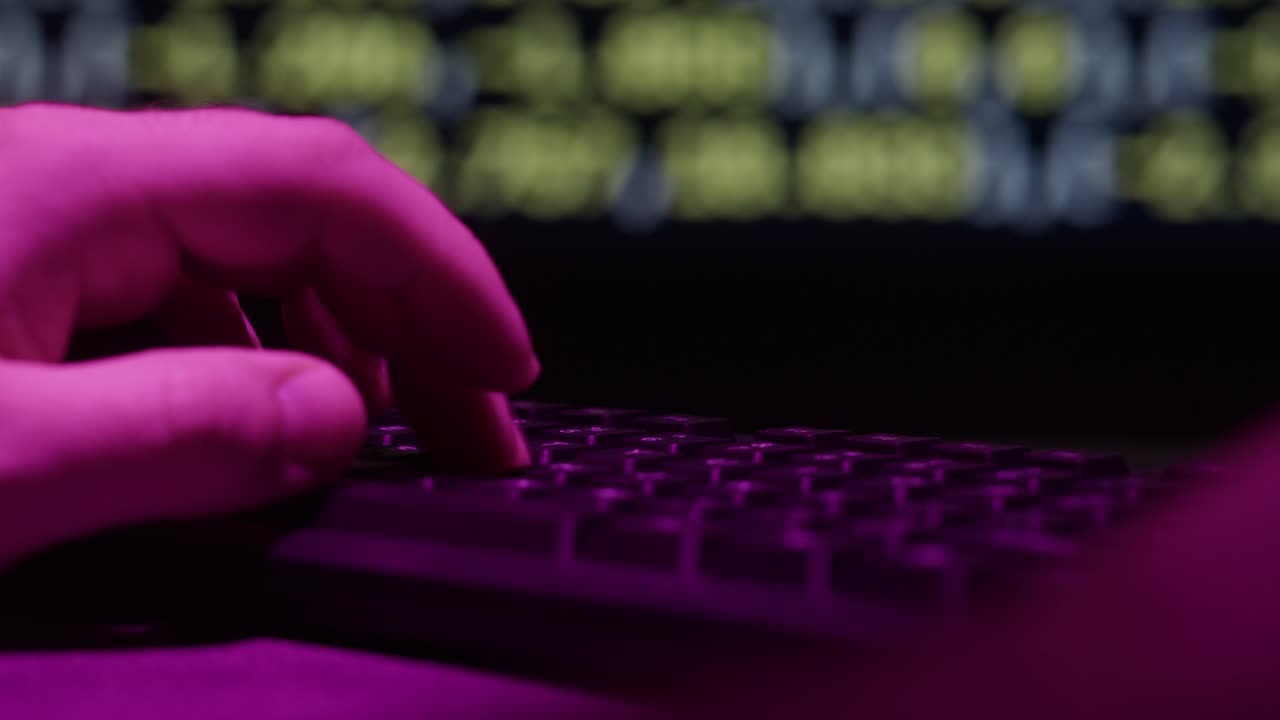 Person typing on a keyboard at night