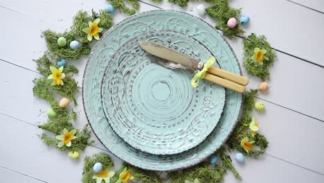 Easter-table-setting-with-flowers-and-eggs--Empty-decorative-ceramic-plates