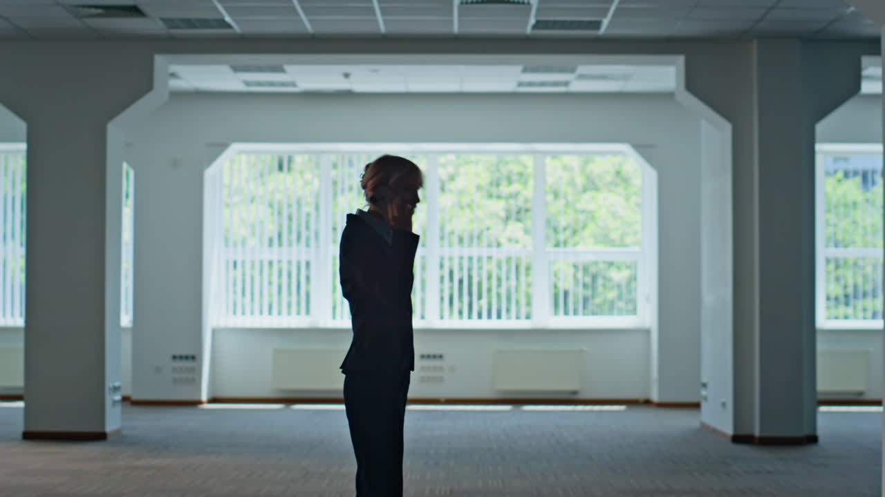 Angry lady shouting smartphone walking at office hall. Businesswoman quarrelling