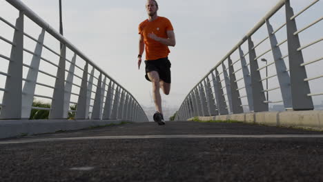 sporty caucasian man training on a bridge