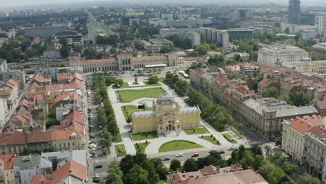 Traffic-In-The-Road-Near-Art-Pavilion-Building-In-King-Tomislav-Square,-Zagreb,-Croatia