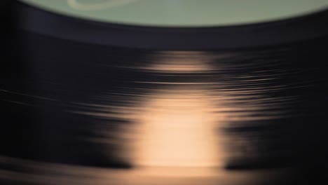 Close-up,-macro-shot-of-old-vinyl-disc-spinning-on-a-record-player