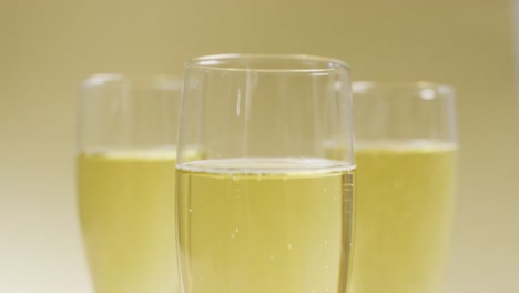 Video-of-champagne-in-glasses-on-yellow-background