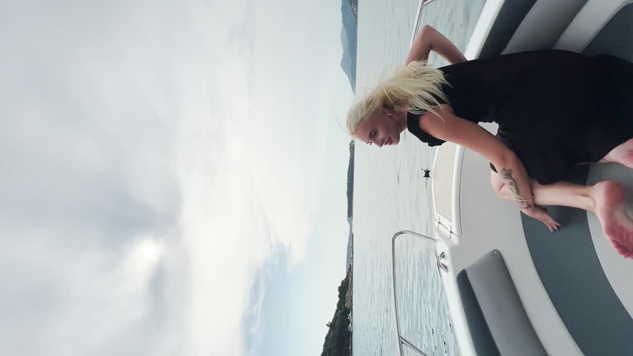 Young woman sitting on a boat deck enjoying the view of the sea, Croatia