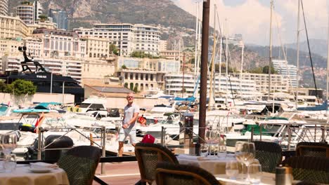 man strolling past yachts in monte carlo