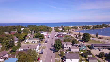 forward aerial along street by lake superior in grand marais, michigan