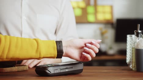 paying with smartwatch in cafe. contactless food shopping. nfc technology concept, fitness bracelet payment. buying food or drinks in cafe, restaurant.