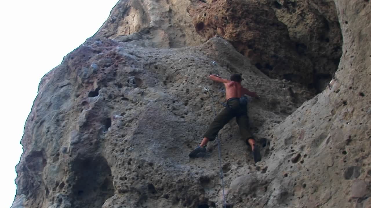 panright de un escalador escalando la pared de un acantilado