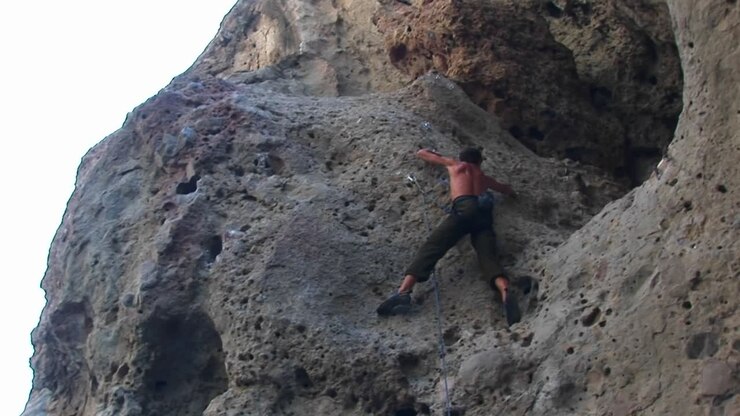 Panright Of A Rock Climber Scaling A Cliff Wall