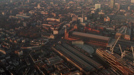 Circling-aerial-shot-around-Kings-Cross-st-Pancras-train-station-at-sunrise