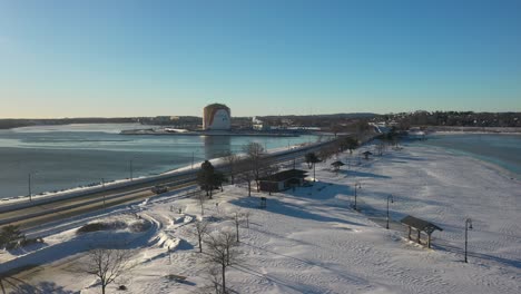 drone shot following snowstorm in winter with sun and blue skies