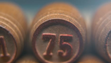 cinematic macro smooth shot of bingo wooden barrels in a row, woody figures, old numbers vintage board game, lucky number 75, slow motion, 4k commercial gimbal movement, dreamy lighting, tilt up