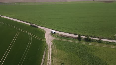 Aerial-shot-of-camper-parked-in-the-middle-of-a-vast-field