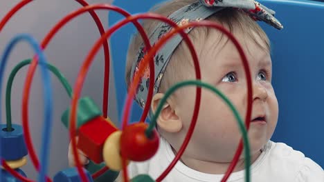 child plays with a multi-colored toy 21