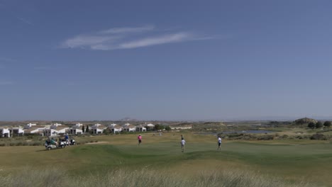 4K-60FPS-video-of-golfers-finishing-on-the-18th-hol-of-a-golf-course-in-spain