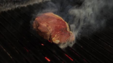 juicy steak grilling on a hot grill