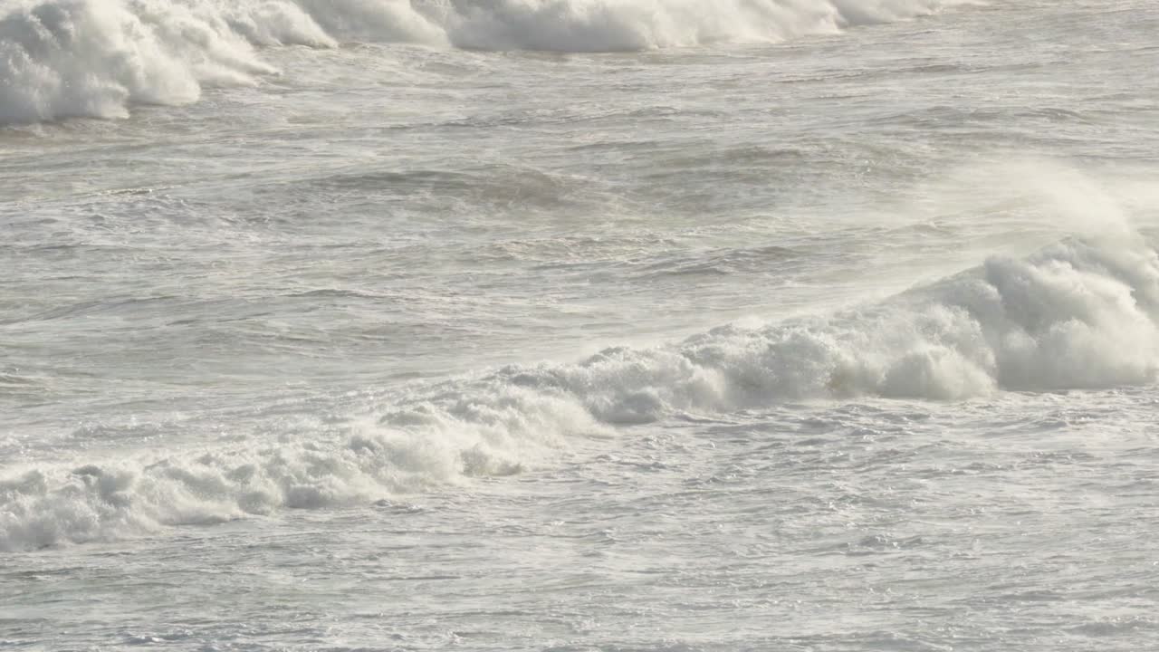 Dynamic ocean waves crash against the shore, captured in natural lighting along Australia's scenic Great Ocean Road