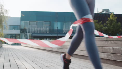 athletic fitness sport runner woman finishing racing competition celebrating victory in city park