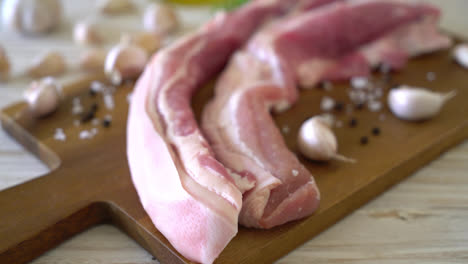 fresh raw streaky pork on wood board with ingredient