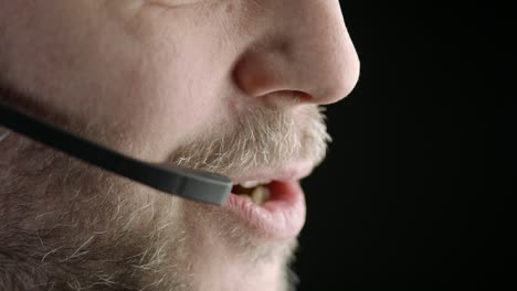 isolated on black background, close bearded male phone operator talks