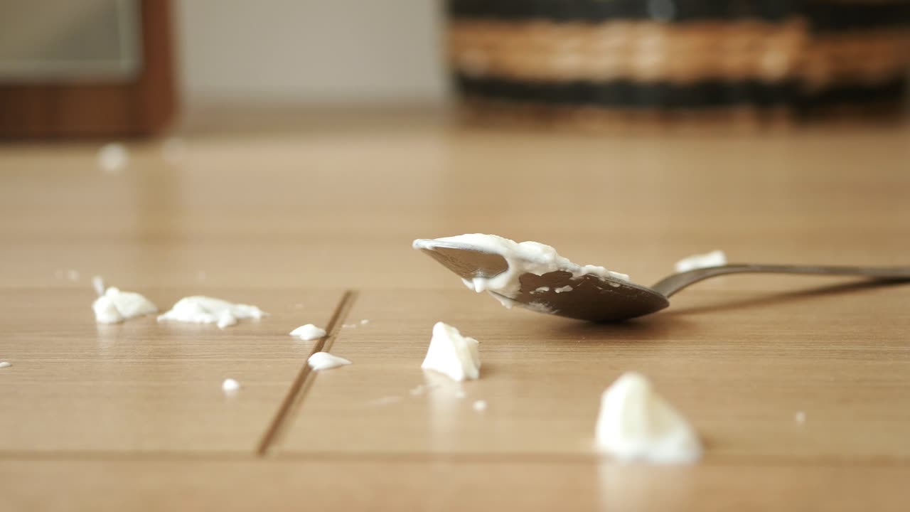 Closeup of a spoon with yogurt on a table