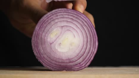 chef slices shallot for cooking