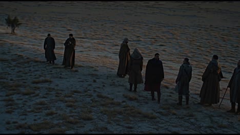 group of people in desert landscape