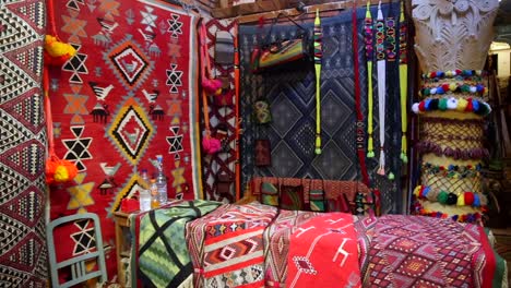 colorful carpet and textiles stand in the souks streets, tunisian traditional objects