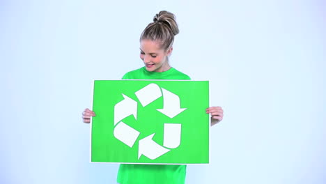 blond woman holding a banner for the environment