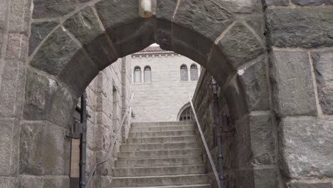 stairs under ancient stone arch in the cloisters, new york