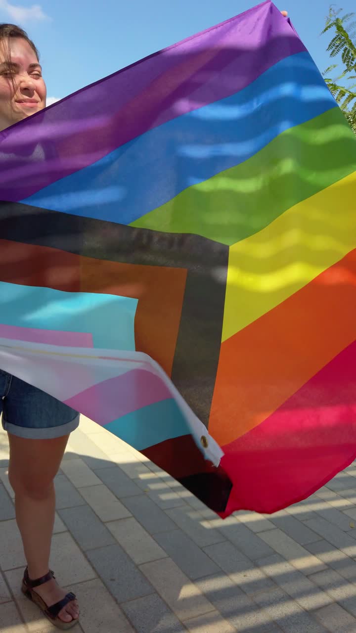 Progress Pride Flag Waving in Urban Park