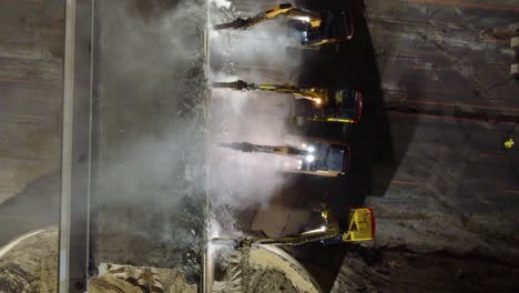 Aerial-topdown-view-of-excavators-demolishing-concrete-bridge