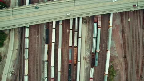 top down of multi rail tracks, many trains with freight