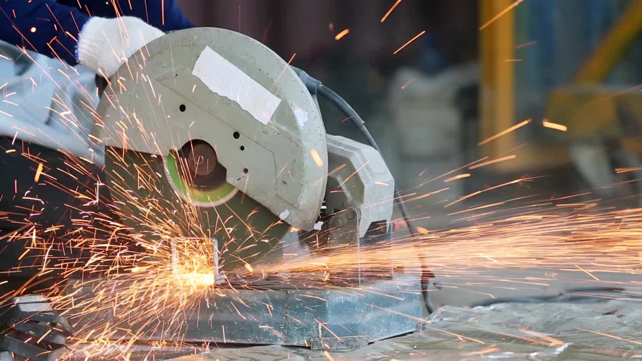 резка стали с брызгами искр, обработка металла угловой шлифовальной машиной. искры в металлообработке.