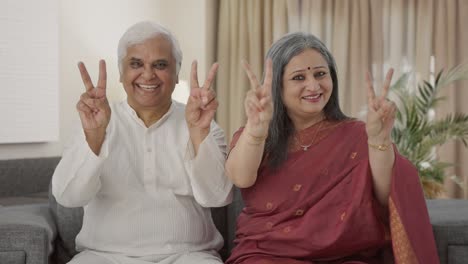 Happy-Old-Indian-couple-showing-victory-sign