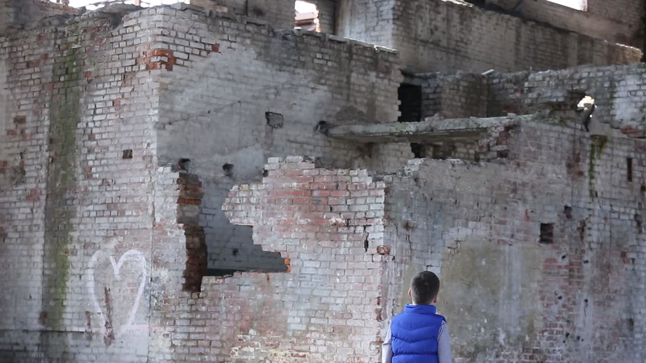 Boy Walk In Destroyed House. Frightened at the lost boy walk in destroyed house