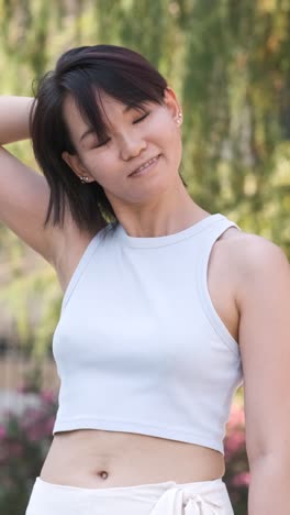 confident woman wearing crop tank top in city park during daytime