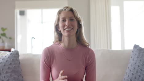 portrait of happy caucasian woman talking and having video call at home, slow motion