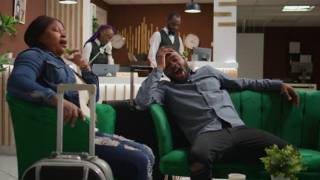 exhausted people resting in hotel lobby