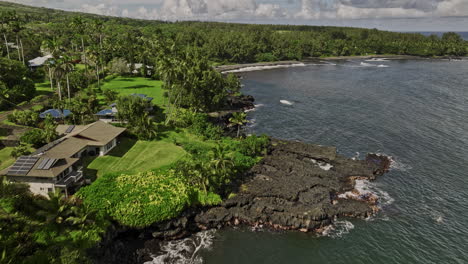 hana maui hawaii aerial v10 fly along rugged shorelines capturing seaside residential areas, dark volcanic rocks, lush greenery and scenic hillside landscape - shot with mavic 3 cine - december 2022