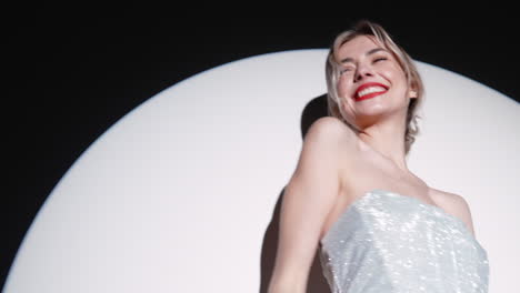 elegant woman in a sparkling dress under spotlight