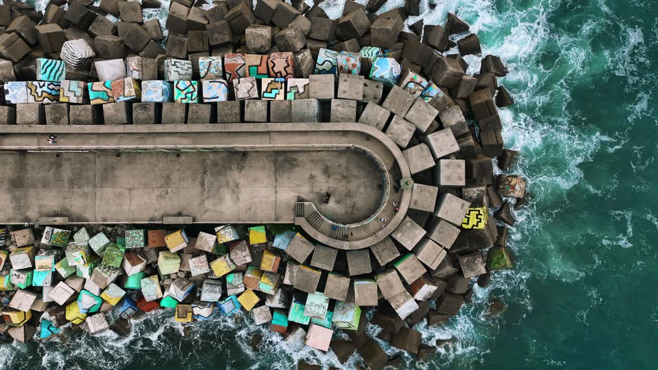 The drone is flying topdown going up above the pier Los Cubos de la Memoria in Bilboa Spain Aerial Footage 4K