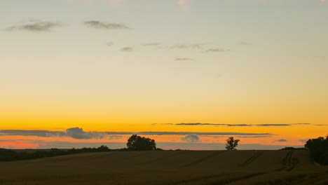 clouds soaring high over the vast farmland in zlotoryja, poland on a glorious sunset - golden hour - timelapse