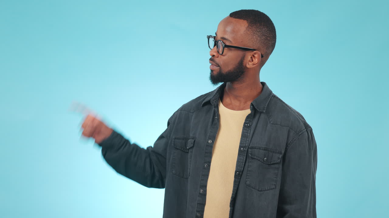 Pointing, options and face of black man in studio