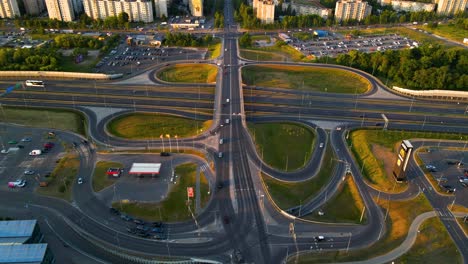 Aerial-of-the-traffic-on-the-highway-and-the-interchange-with-buildings-in-the-background