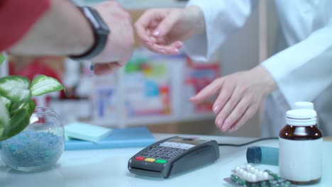 Man-buy-blister-pills.-Credit-card-machine-at-drugstore