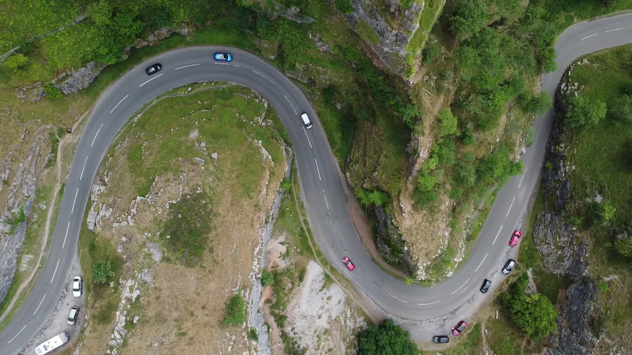 Static top down aerial view of a road twisting round the limestone cliff formations at Cheddar gorge in the Mendip Hills, Somerset, UK