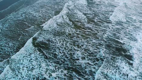 Top-down-drone-footage-of-a-man-kitesurfing-the-waves-of-the-north-sea