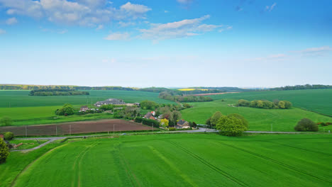 drone captures burwell village's historical shift from medieval market town—countryside fields, classic red brick houses, and the disused saint michael parish church on lincolnshire's wold hills