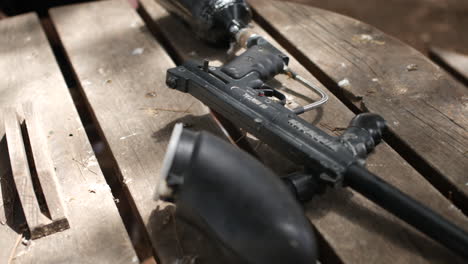 a paintballing paint ball gun on a wooden table